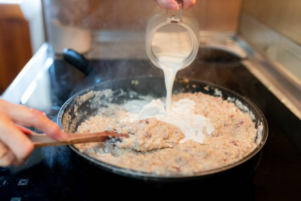 istock Person adding milk to the croquette dough in a pan 2060225341