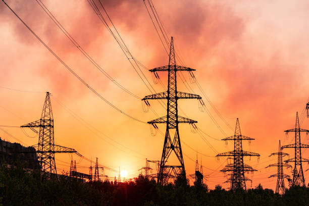 istock A Serene Sunset Casting Shadows on Overhead Power Lines. The sun is setting behind the power lines 2060236510