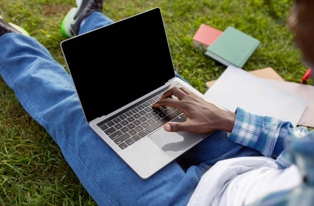 istock Unrecognizable African American young man typing on laptop in park 2060249907