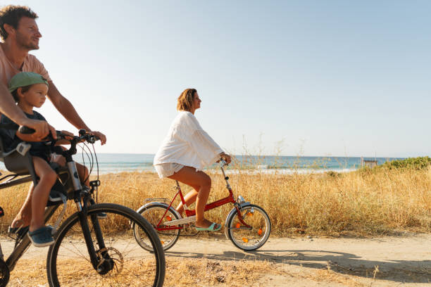 istock Young family exploring coastline on bicycles in summertime 2060252222