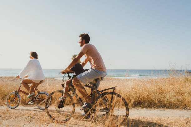 istock Young family exploring coastline on bicycles in summertime 2060252231