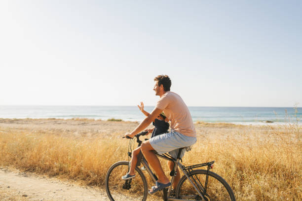 Young couple with fat bike taking a selfie with the mobile on the beach
