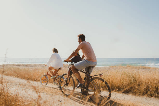 istock Young family exploring coastline on bicycles in summertime 2060255216