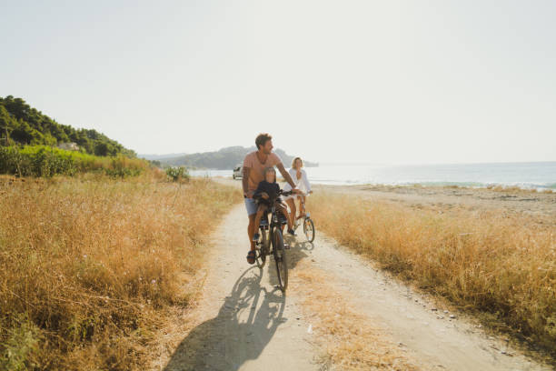 istock Young family exploring coastline on bicycles in summertime 2060256636