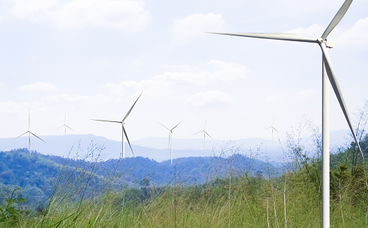 Wind Mill Power Energy Farm Generator Renewable Sustainable Field on Green Lnadscape Mountain, Environment Eco System Technology Industry Ecology Electricity Power Propeller Turbine Clean Carbon.