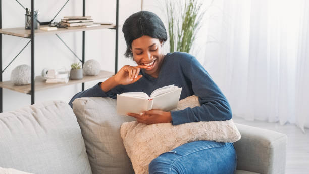 istock Reading book relax home leisure woman cozy couch 2060272261