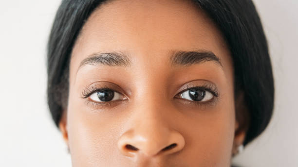 Eyes health. Vision correction. Sight clinic. Ophthalmology services. Young beautiful calm woman face portrait isolated on white background.