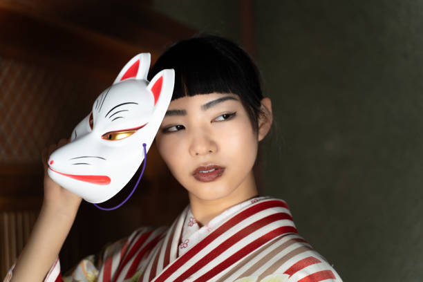 istock A woman in Japanese clothes with a fox mask 2060275706