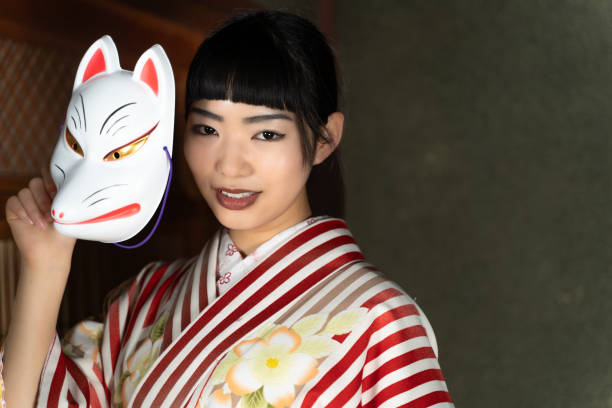 istock A woman in Japanese clothes with a fox mask 2060277315