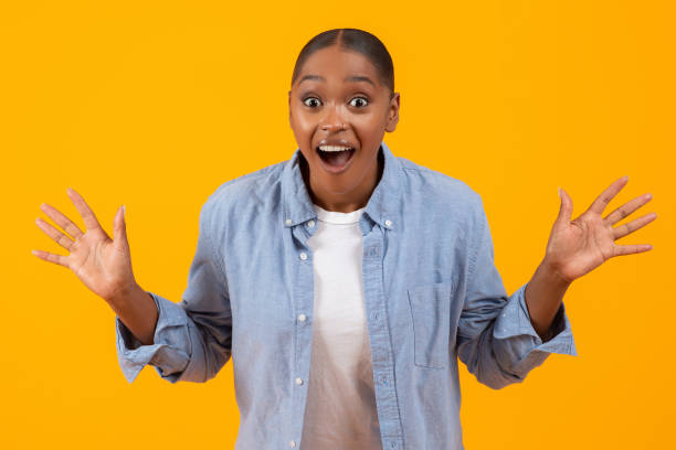 istock Joyful Black Lady Shouting Omg In Excitement Against Yellow Background 2060277876