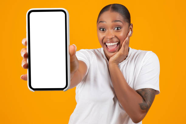 istock Cheerful African American Woman Showing Big Cellphone Blank Screen, Studio 2060278425