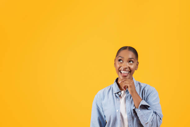 istock Dreamy african american young woman looking at free space, studio 2060278472
