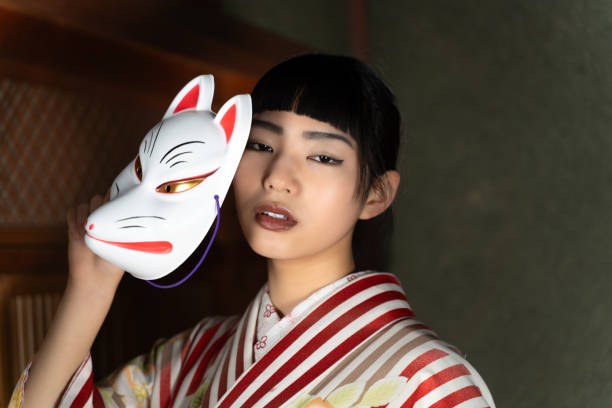 istock A woman in Japanese clothes with a fox mask 2060280143