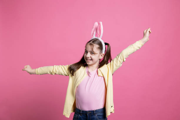 istock Joyful small child with pigtails dancing around in front of camera 2060280674