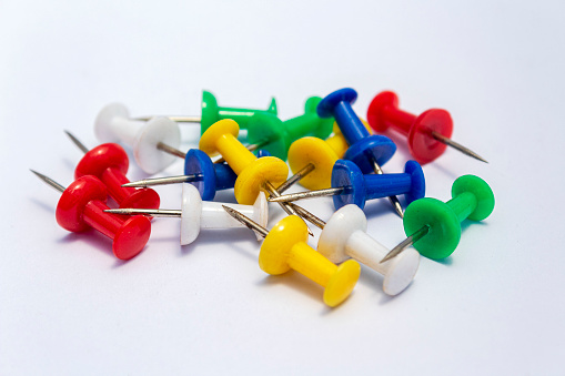 pile of colorful push pins isolated on white background