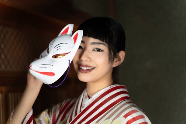 istock A woman in Japanese clothes with a fox mask 2060281254