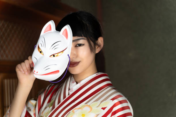 istock A woman in Japanese clothes with a fox mask 2060281793