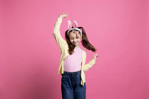 istock Energetic and positive kid dancing in studio while wearing bunny ears 2060285048