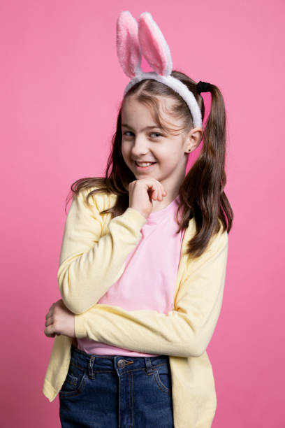 istock Little schoolgirl thinking about easter presents and celebration 2060290077