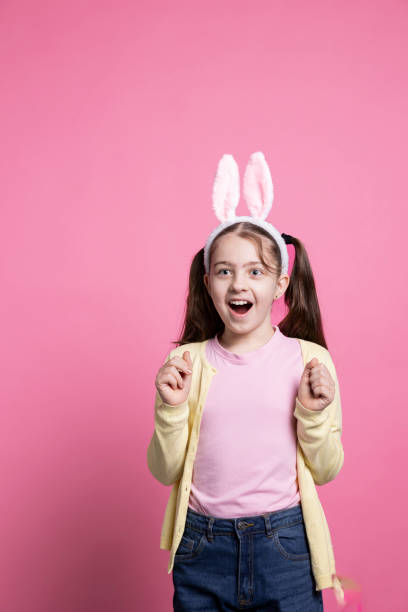 Excited optimistic girl acting amazed by easter presents in studio