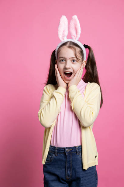 istock Enthusiastic positive kid acting surprised by easter gifts in studio 2060291208