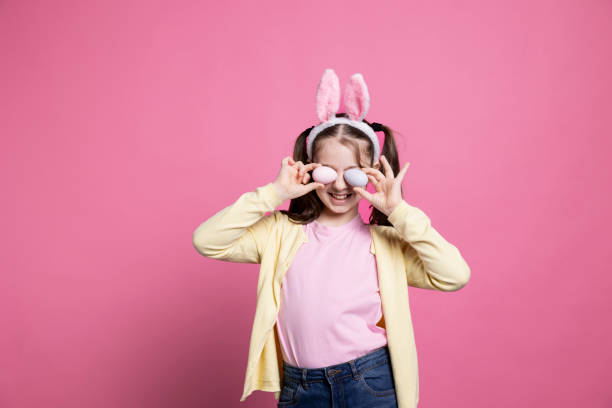 istock Cheerful child with bunny ears fooling around in studio 2060292304