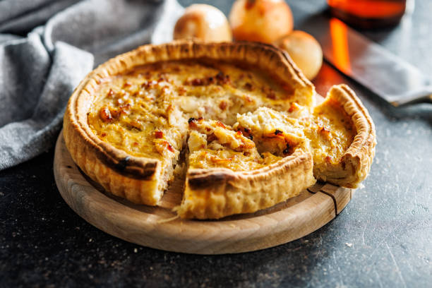 Traditional french pie. Quiche lorraine on kitchen table.