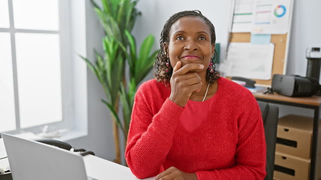 Thoughtful african woman professional pondering in modern office room.