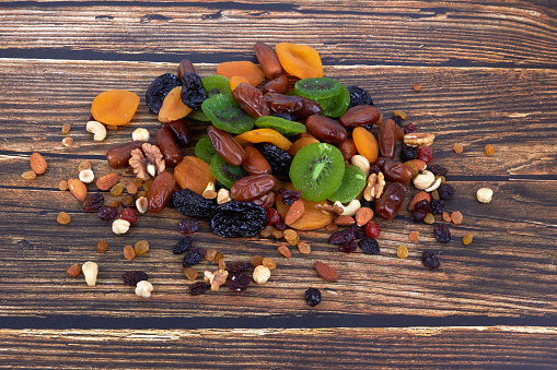 Dry fruits on a wooden background