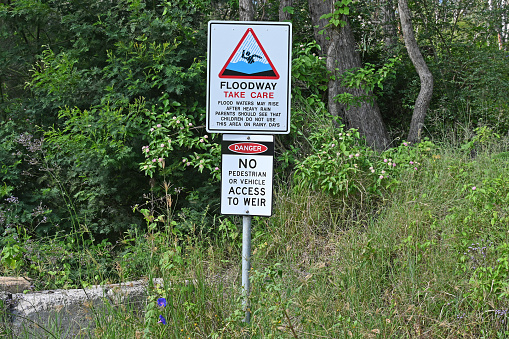 Danger floodway sign next to an old weir