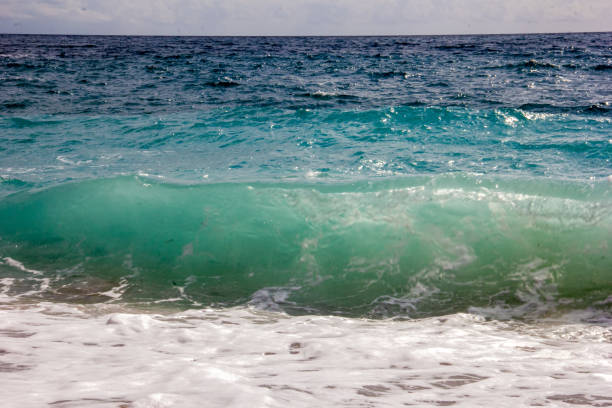 Adriatic sea and sky, a wave rolls onto the shore
