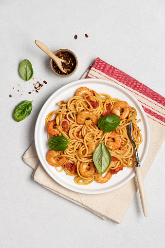 Shrimp marinara sauce pasta in plate on white background