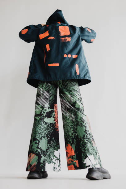 istock Cool Woman Is Seen From The Back, Wearing A Multi-Colored Jacket And Flare Pants With Black Boots Fashion Portrait 2060339875