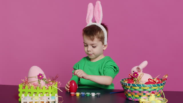 Adorable little youngster creates handcrafted ornaments for Easter Sunday