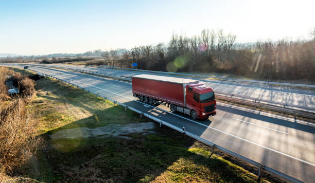 istock Red Truck on a rural countryside highway 2060351593