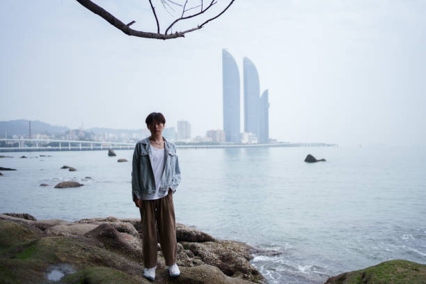 young man standing on the beach