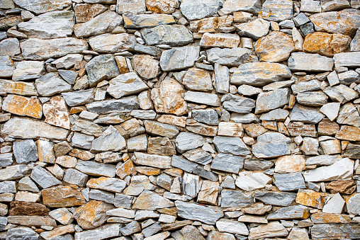 Gray stone wall made of natural stone.