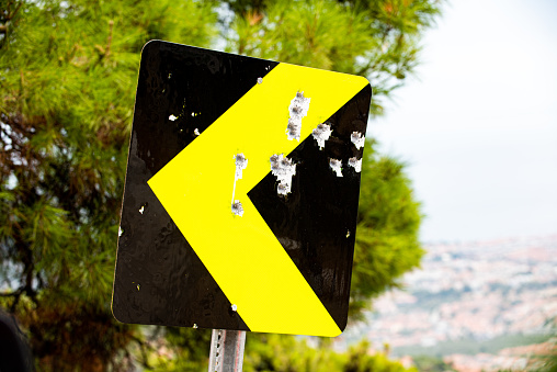 A close view of the yellow warning signs on the side of the road.