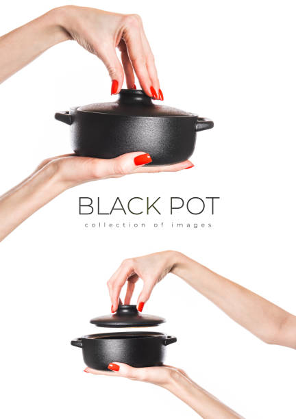 Black pot in hands isolated on white background. High quality photo. High quality photo