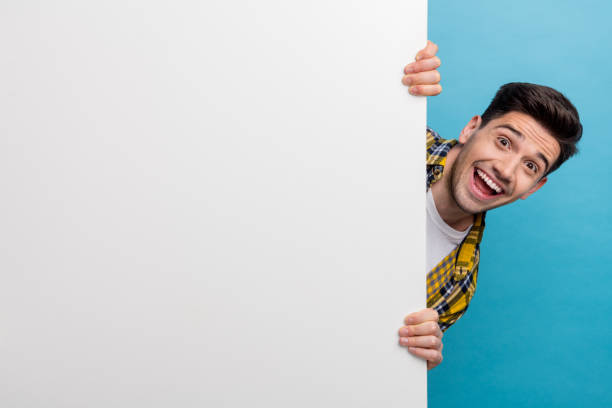 istock Photo of guy hide billboard amazed big billboard white wall demonstrating technical specifications ad isolated on blue color background 2060379513