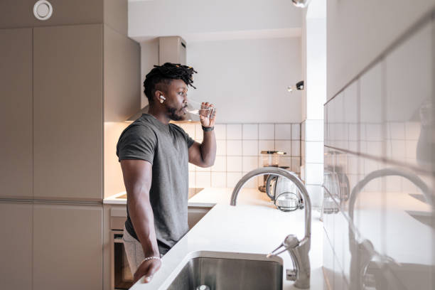 istock A handsome black man drinking a glass of water 2060388054