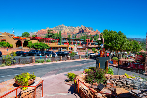 Sedona, Arizona, United States - September 21, 2023: Midday with shops and red rock in the background at down town of Sedona, Arizona, USA