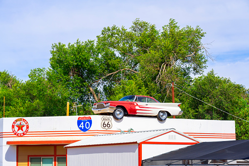 Ash Fork, Arizona, United States - September 22, 2023: 60s era Desoto Car on the roof of a building in Ash Fork, with Elvis driving.