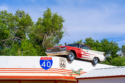 Ash Fork, Arizona, United States - September 22, 2023: 60s era Desoto Car on the roof of a building in Ash Fork, with Elvis driving.