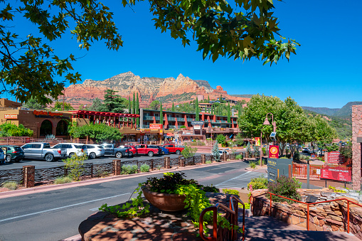Sedona, Arizona, United States - September 21, 2023: Midday with shops and red rock in the background at down town of Sedona, Arizona, USA