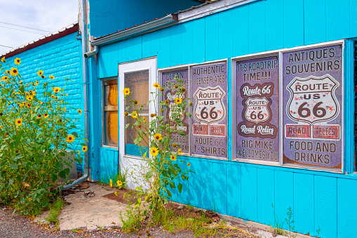 Seligman, Arizona, United States - September 22, 2023: Various Route 66 advertisements on the wall of an old building