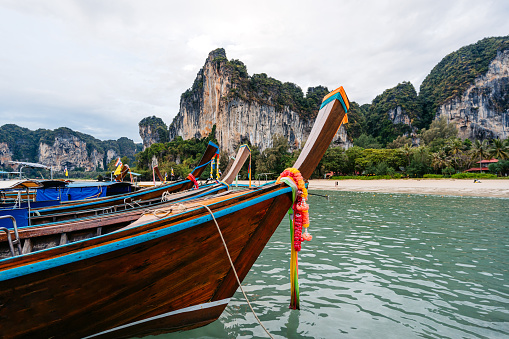 Boats on the Railay beach on the Andaman sea in Thailand.