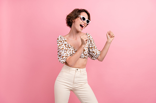 Photo of carefree cheerful person rejoice dancing partying free time weekend isolated on pink color background.
