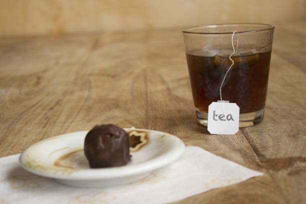 tea in glass with chocolate sweet filled with coffee