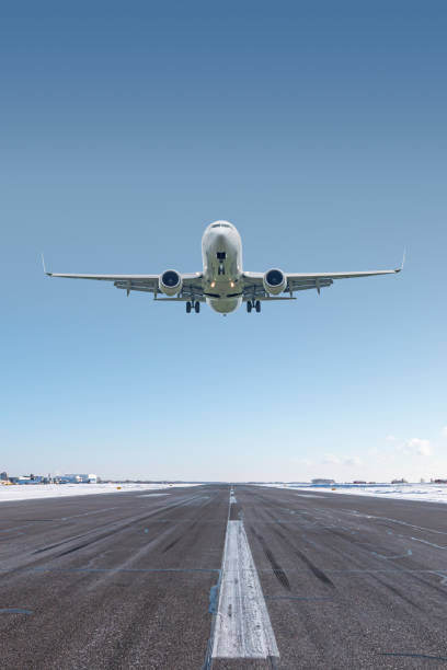 istock White passenger jet plane take off airport runway at winter 2060432112